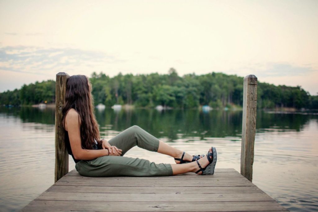 woman beside a lake thinking about meeting someone new
