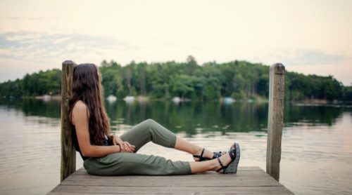 woman beside a lake thinking about meeting someone new