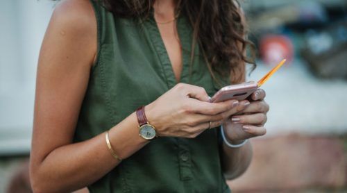 woman using her smartphone figuring out how to flirt over text