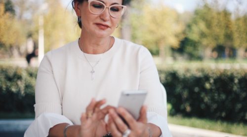 pretty older woman checking out online dating over 50